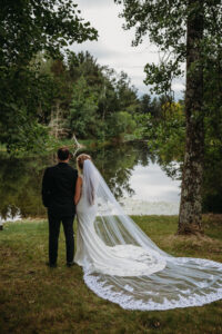 Central Wisconsin Wedding Venues bridge and groom overlooked the lake at Caribou Bay Retreat