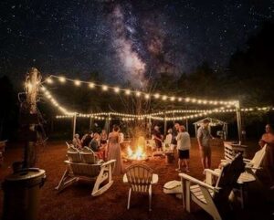 Central Wisconsin wedding venue near Oshkosh at Caribou Bay Retreat – guests around fire pit under string lights at night
