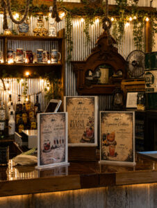Personalized wedding bar with signature cocktail menus and rustic décor at Caribou Bay Retreat, a premier Central Wisconsin wedding venue.
