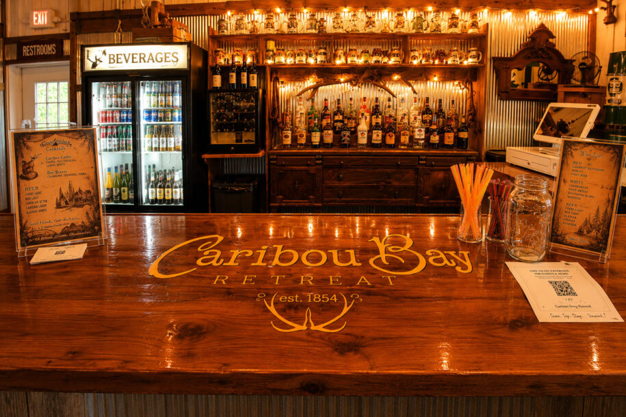 Handcrafted rustic wedding bar at Caribou Bay Retreat, a premier Central Wisconsin wedding venue with signature cocktails and romantic reception atmosphere.